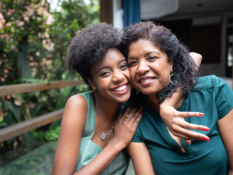 Photo of African American mother and daughter hugging