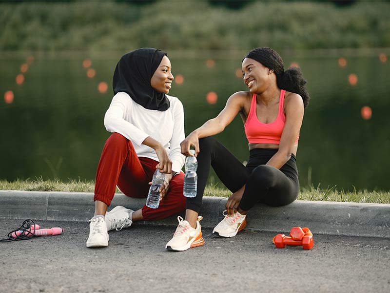Photo of two African American women chatting after a workout