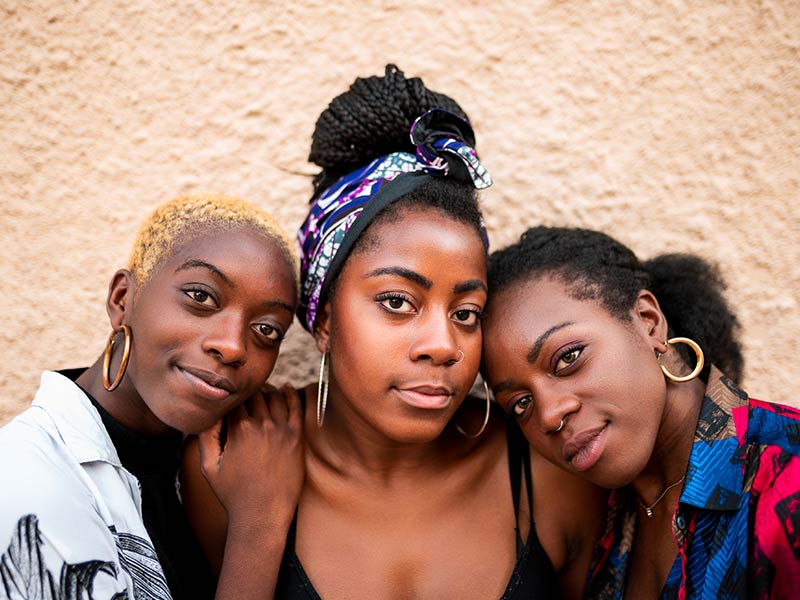 Photo of three African American women embracing